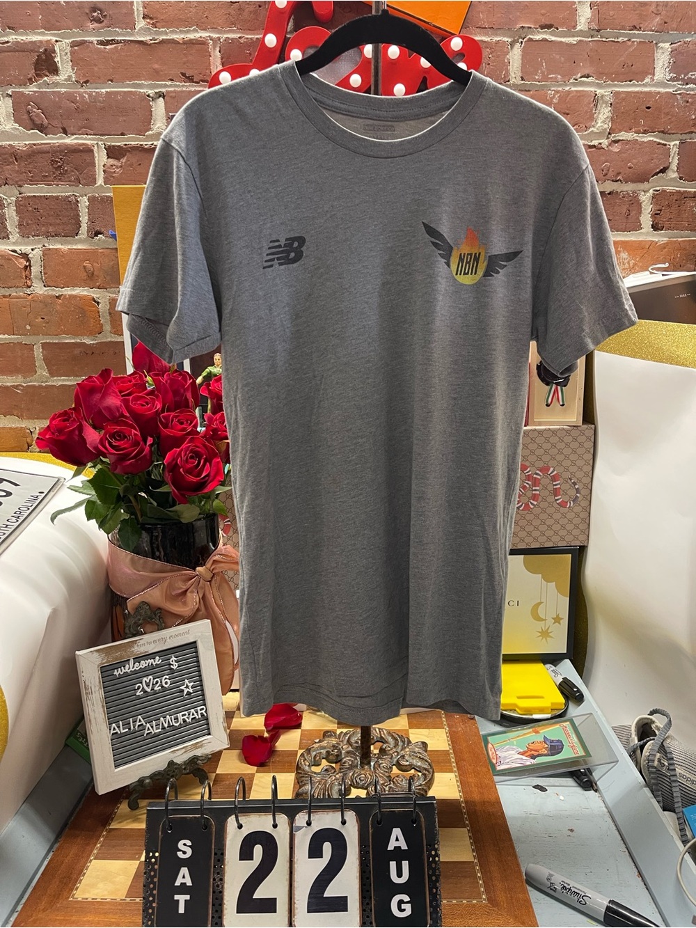 New Balance logo on the right chest and a winged "NBN" flame